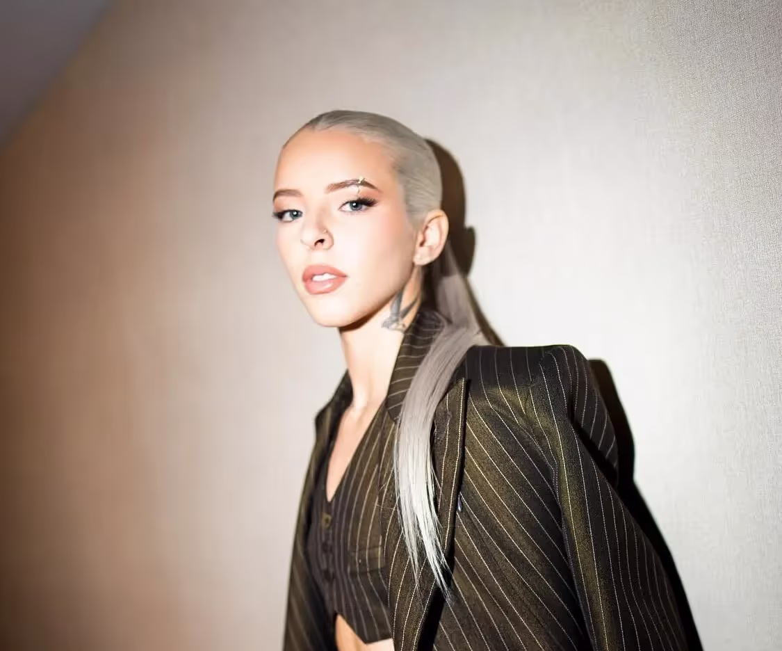 Young Miko with a sleek hairstyle, wearing 3-piece suit