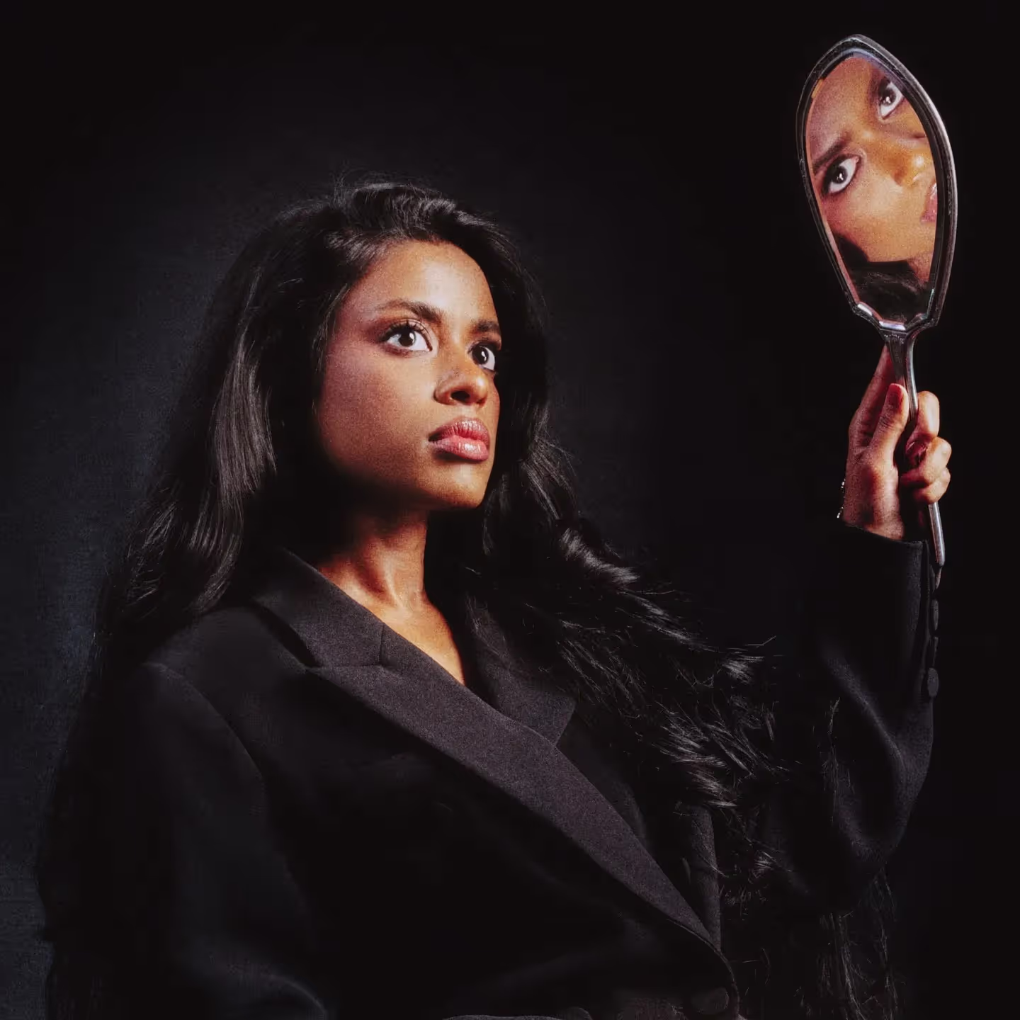 Debbii Dawson wearing black suit and holding a mirror on a cover art of 'Happy World' single