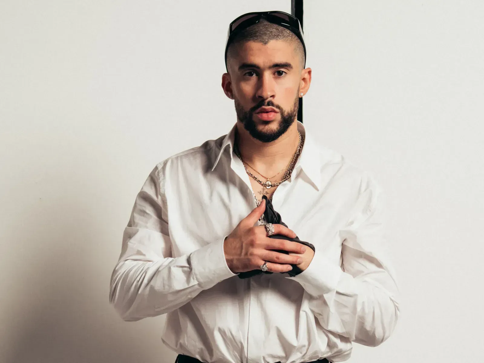 Bad Bunny wearing white short on a shite background