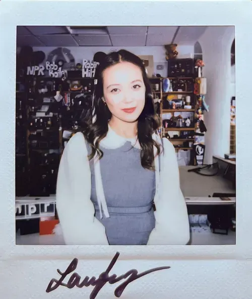 Laufey signs an image of herself after performance at NPR's Tiny Desk on December 12, 2023