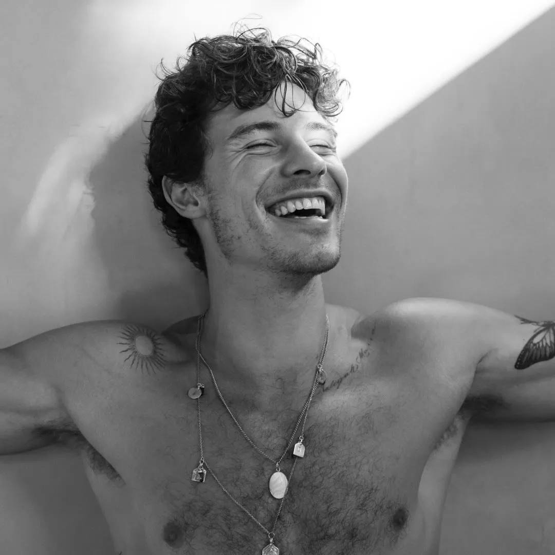 Black and white portrait of smiling Shawn Mendez