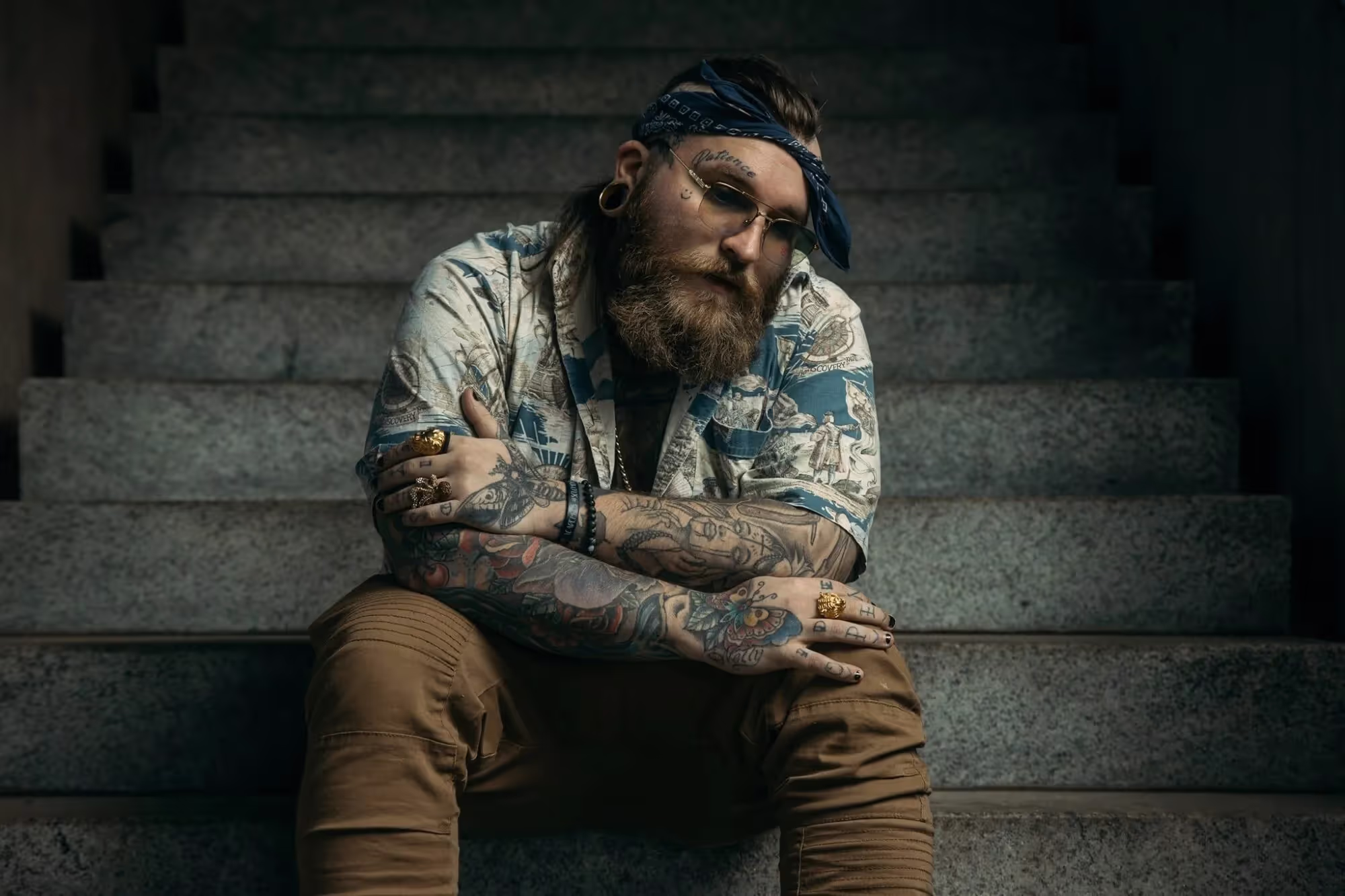 Teddy Swims sitting on the stairs