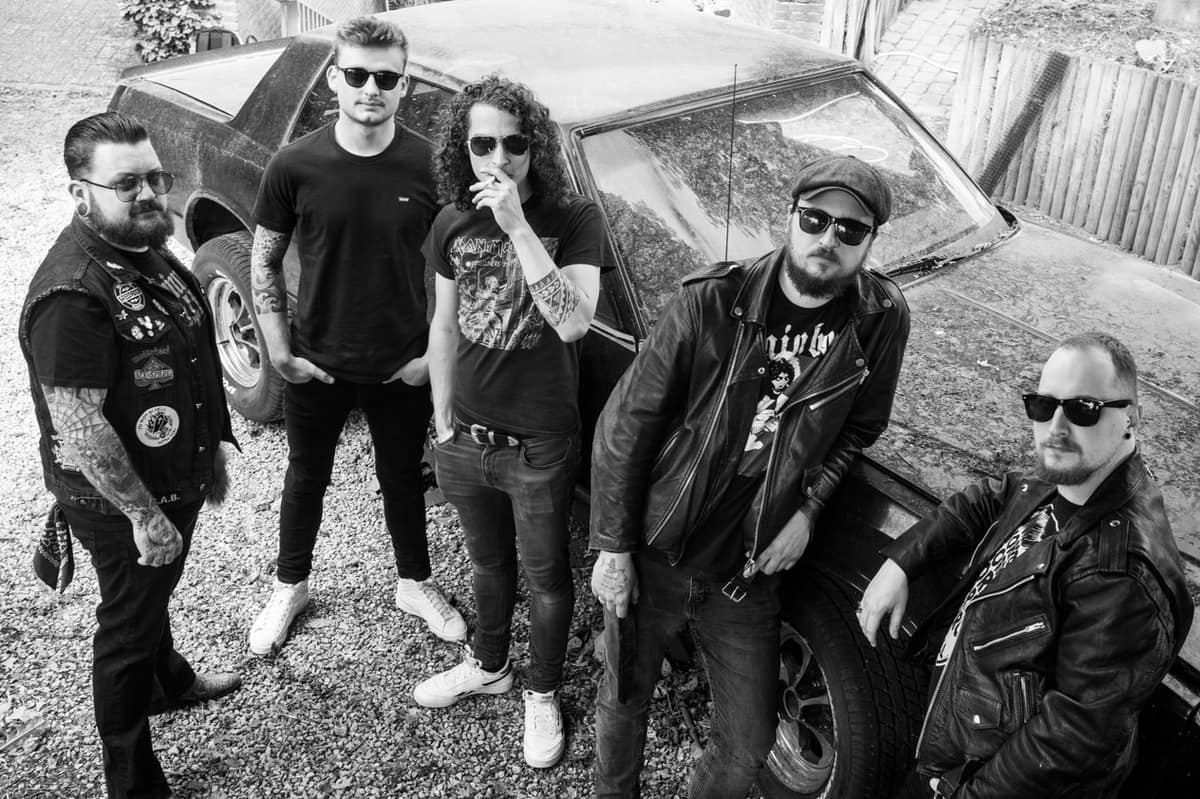 Barrel Smoke group members by the car, black and white