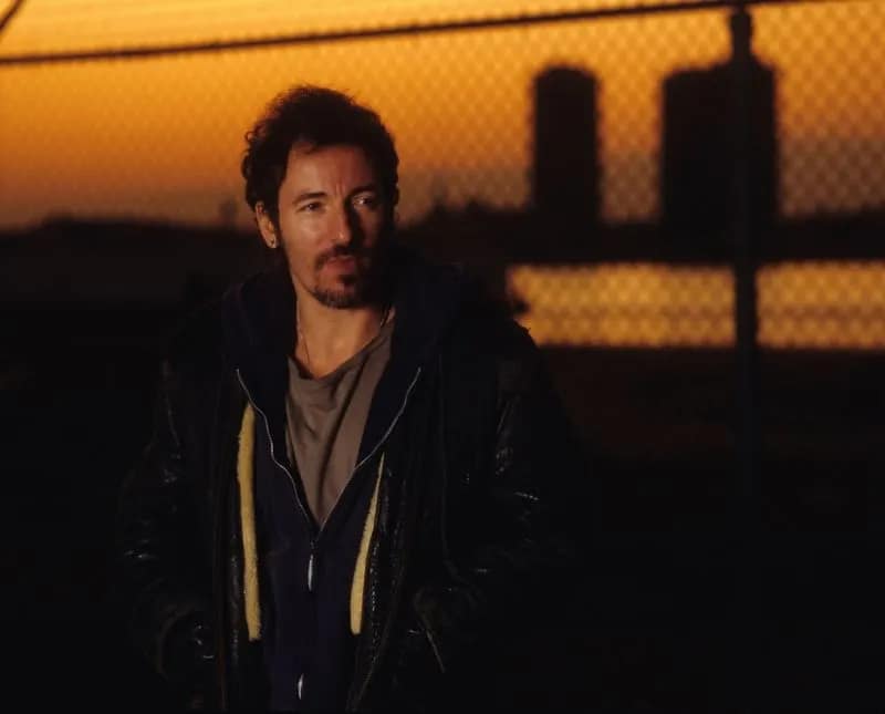Bruce Springsteen against city skyline at sunset for Streets of Philadelphia Sessions Tracks II The Lost Albums