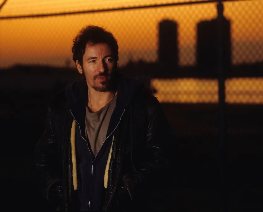 Bruce Springsteen against city skyline at sunset for Streets of Philadelphia Sessions Tracks II The Lost Albums